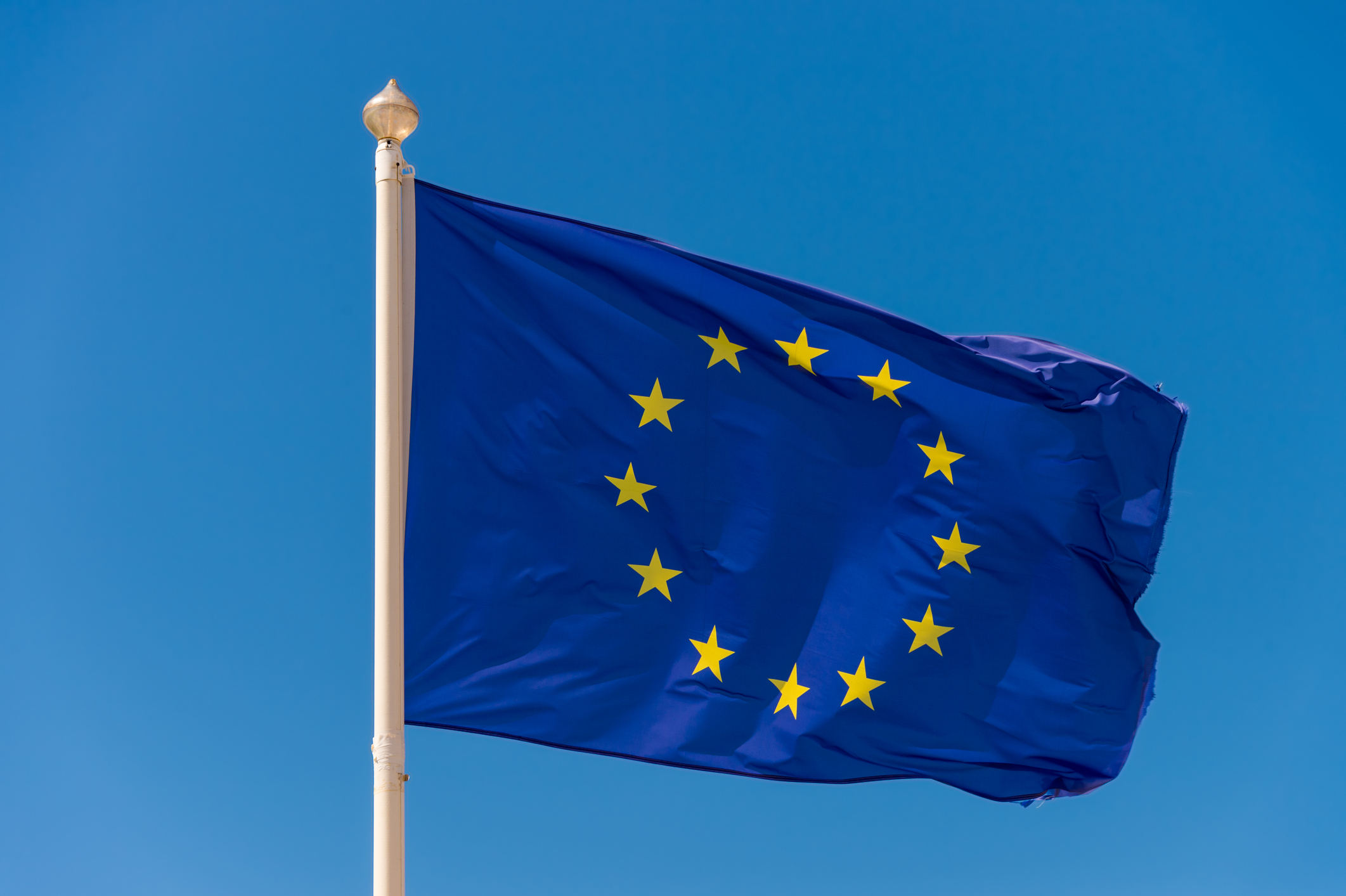 European flag waving against blue sky in Wimereux, France.